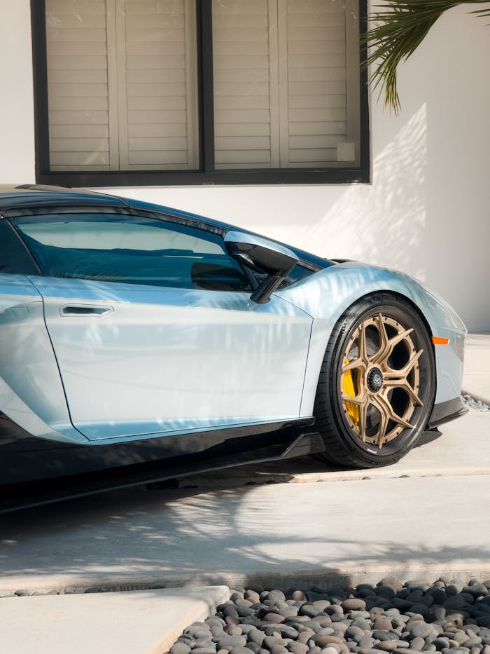 A Lamborghini Aventador sports car elegantly parked in a stylish, contemporary driveway.